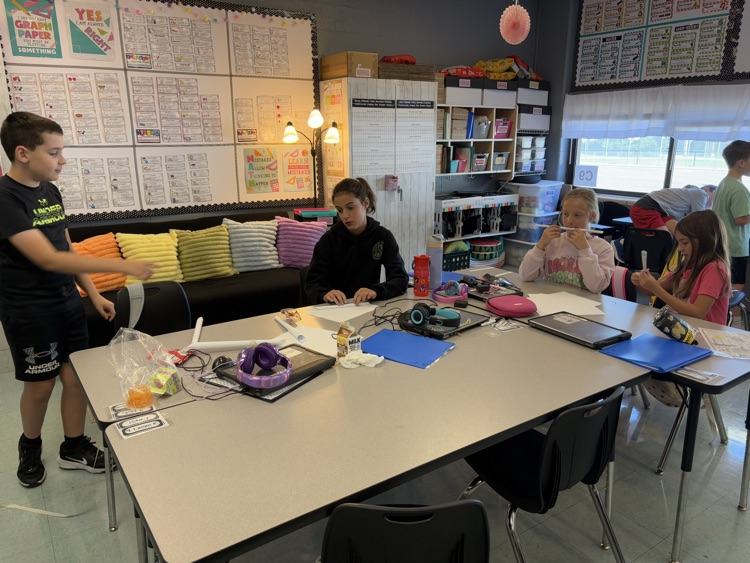 students building a structure to hold books