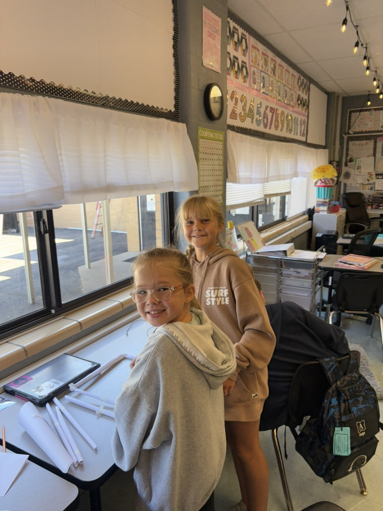 students building a structure to hold books