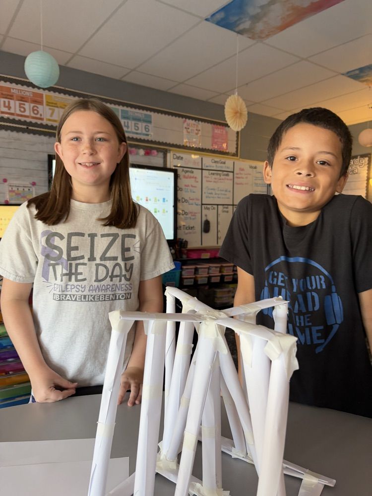 students building a structure to hold books