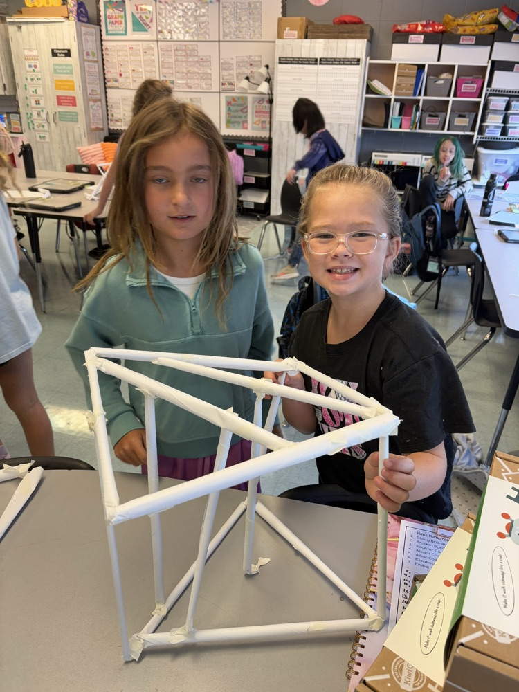 students building a structure to hold books