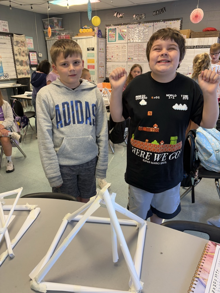 students building a structure to hold books