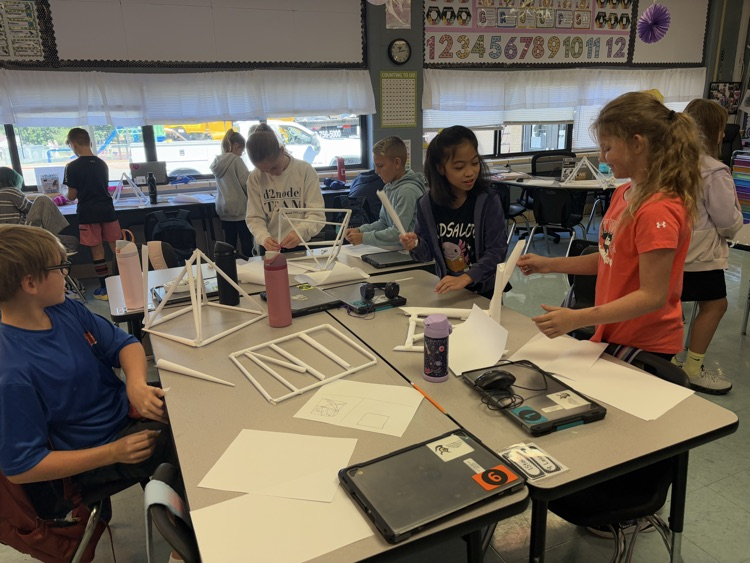 students building a structure to hold books