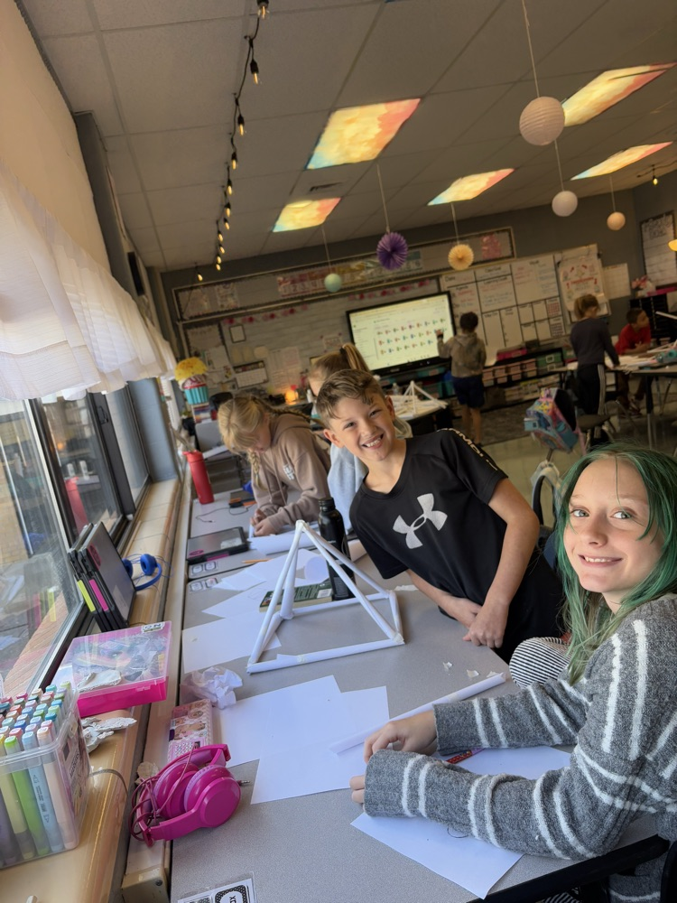 students building a structure to hold books