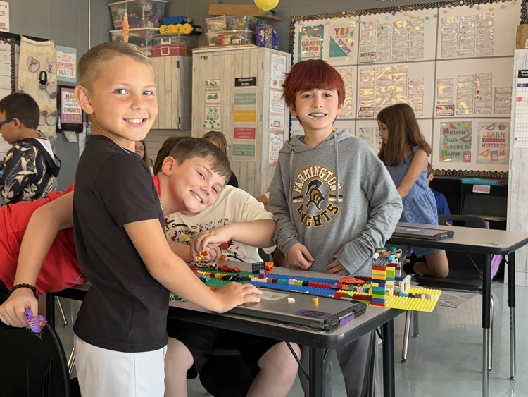 students building with LEGOS 