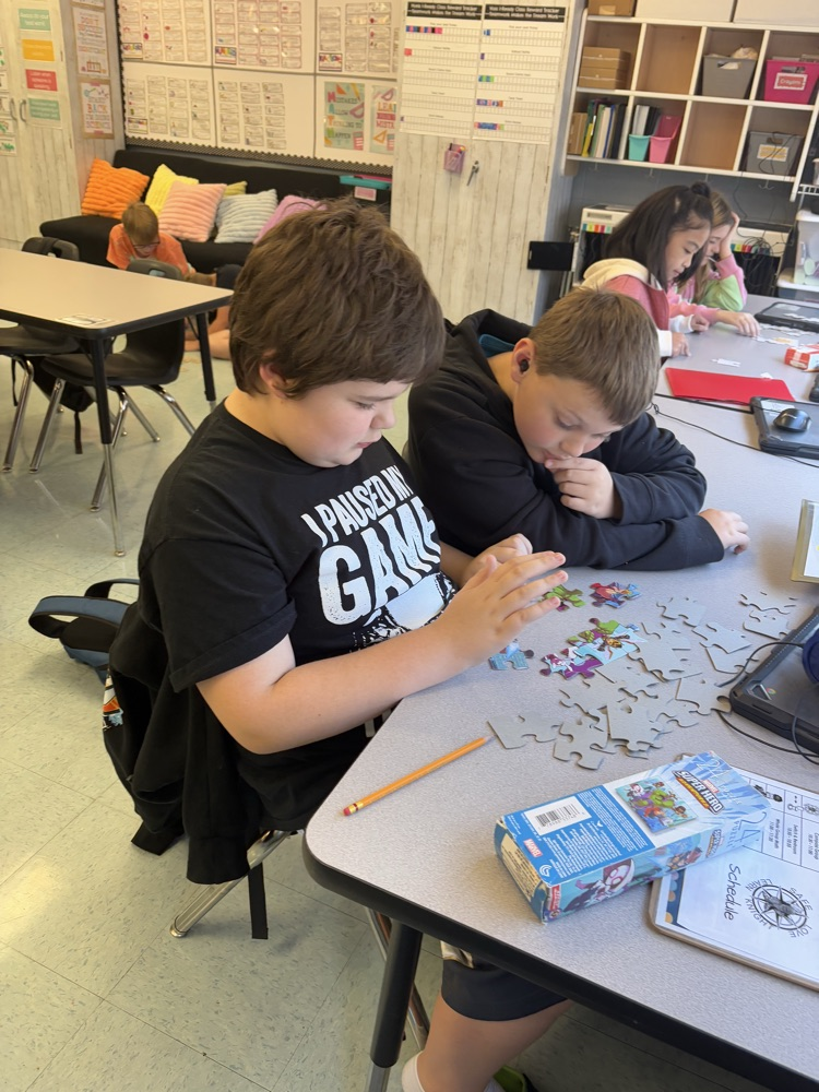 students collaborating on puzzle 