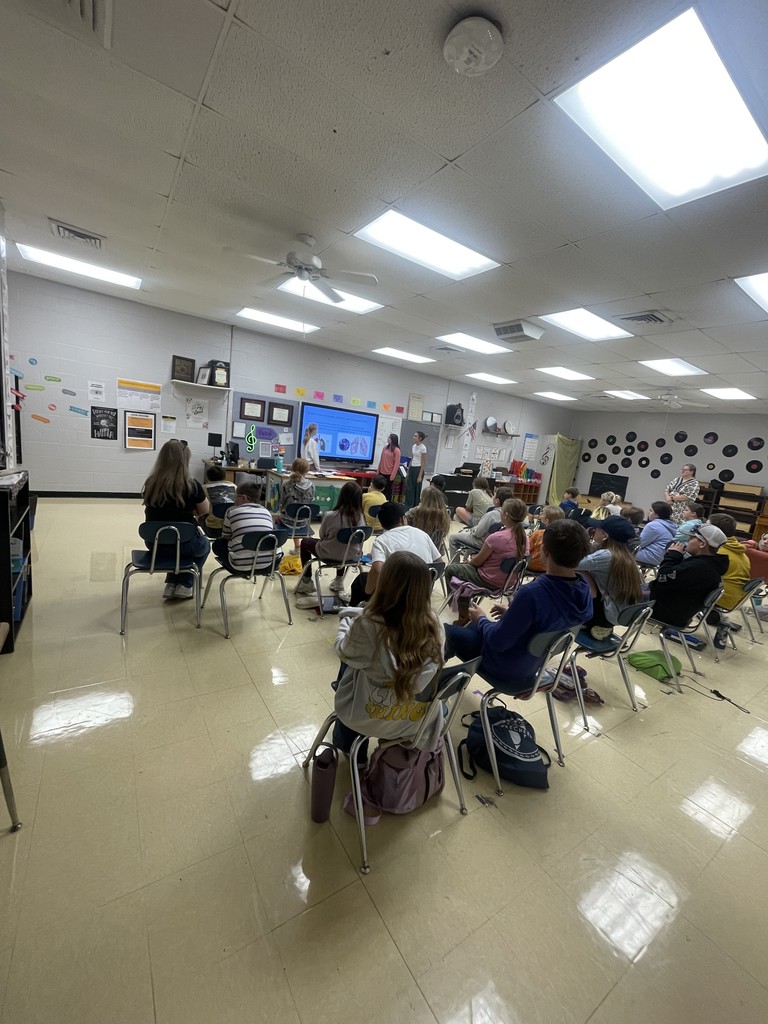 Students in a class presenting to lincoln students