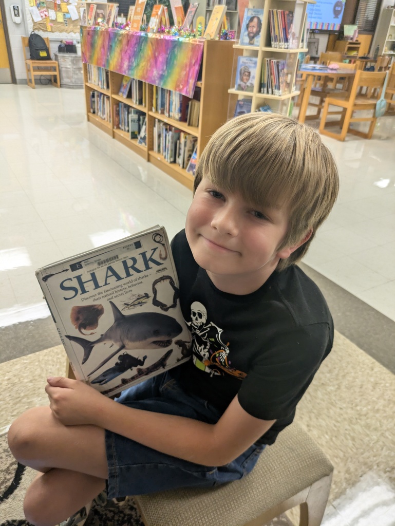 Students sharing the book they are reading.