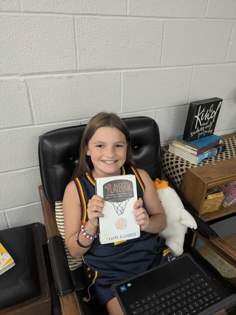 Students sharing the book they are reading.