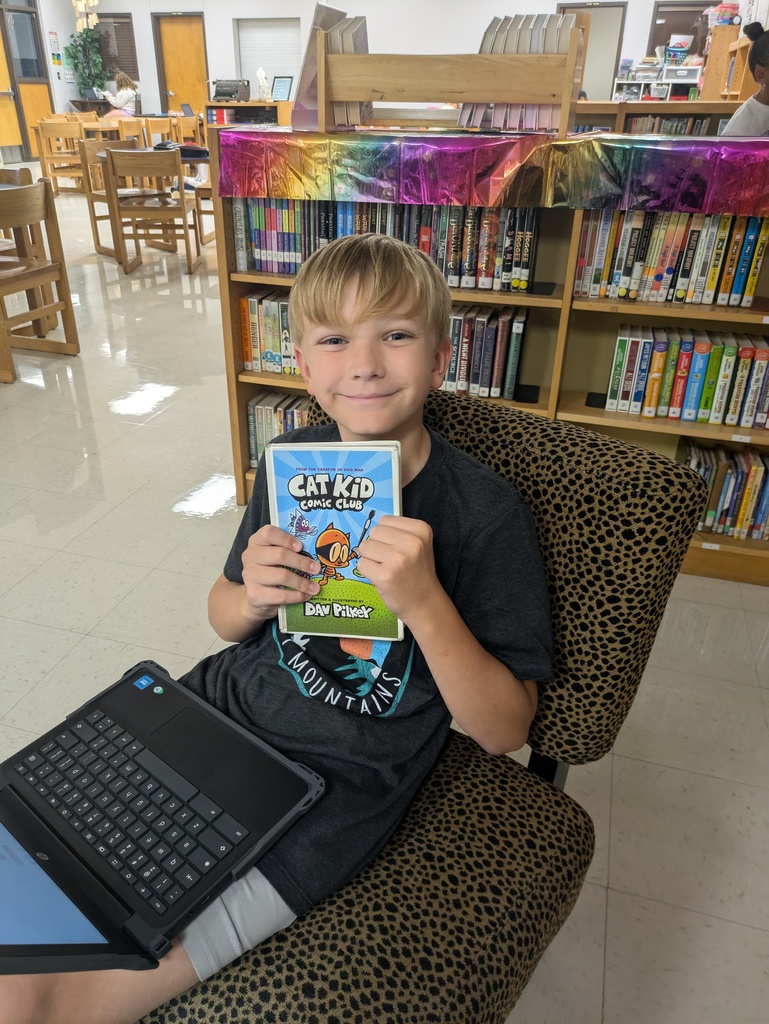 Students sharing the book they are reading.