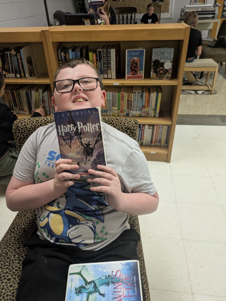 Students sharing the book they are reading.