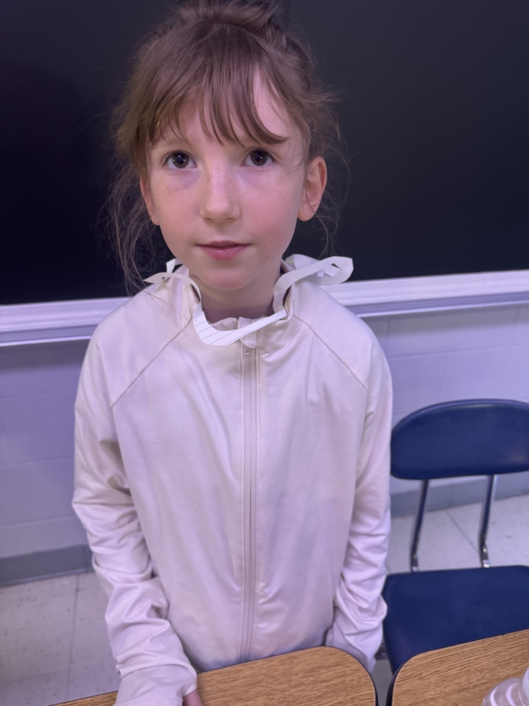 Students with index cards over their heads after completing a classroom activity.