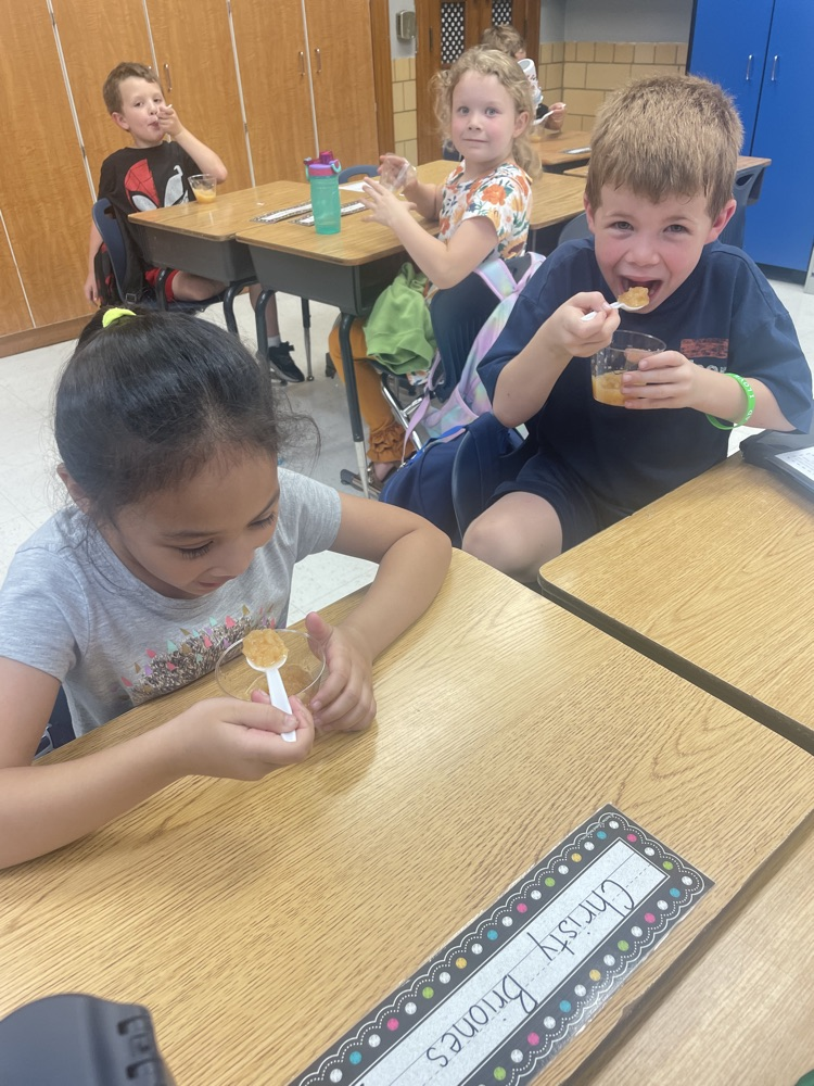 students making/eating applesauce