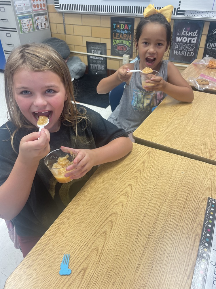 students making/eating applesauce
