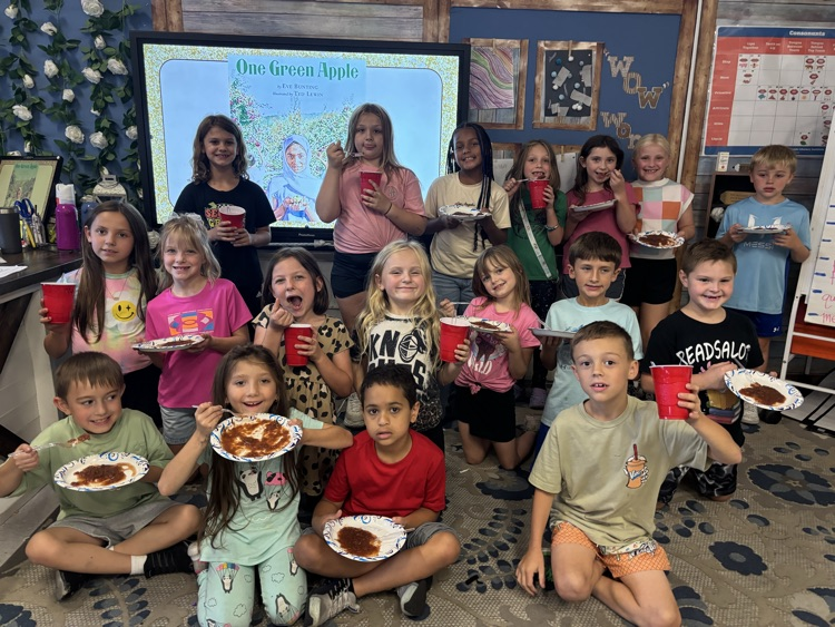 students making/eating applesauce