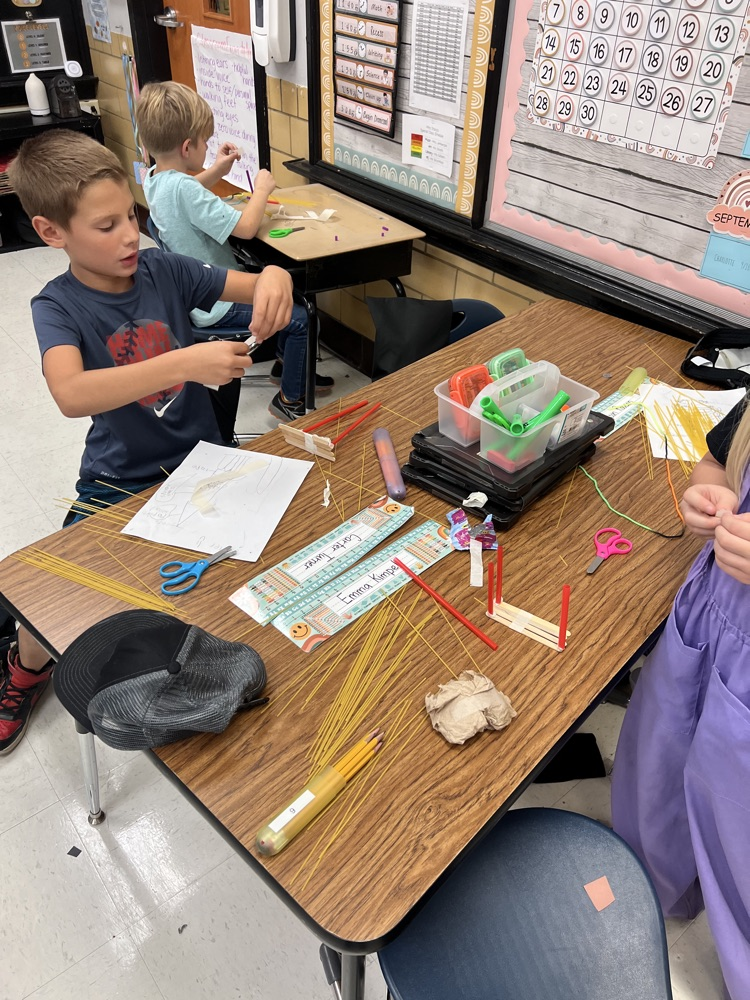 second grade students building towers