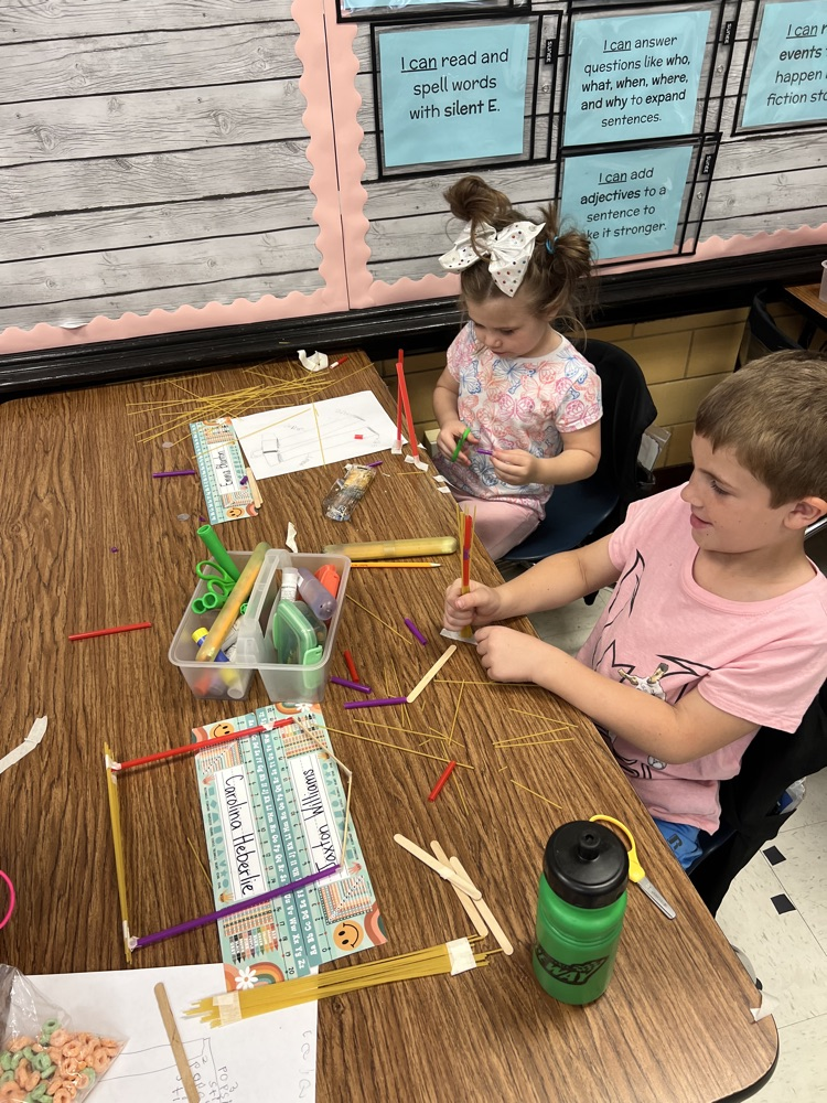 second grade students building towers