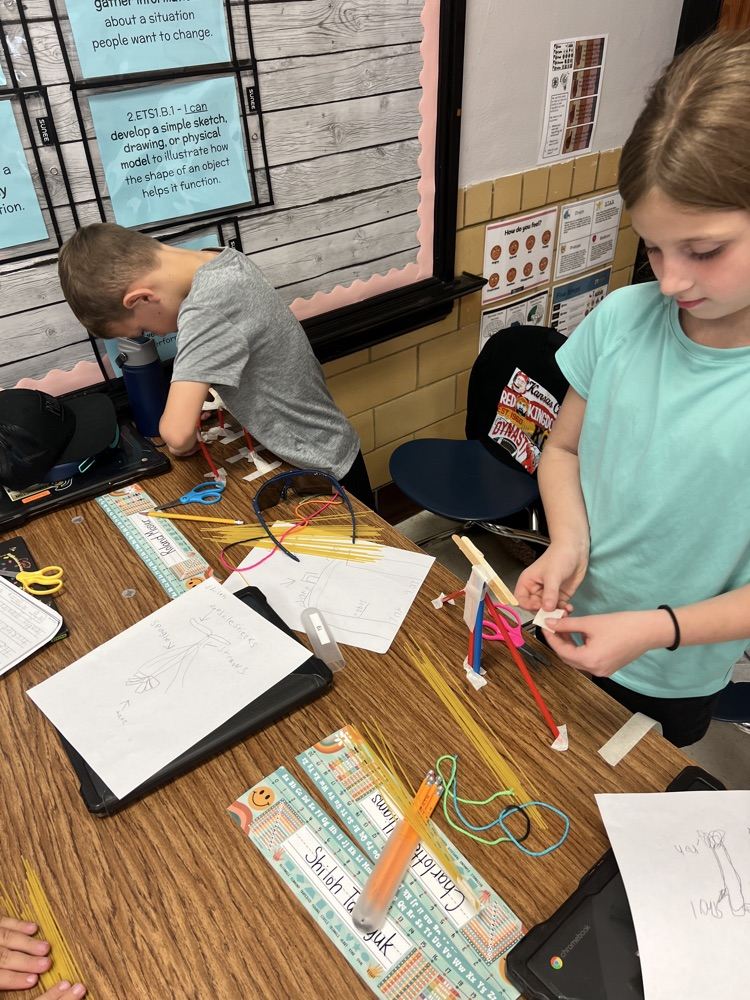 second grade students building towers