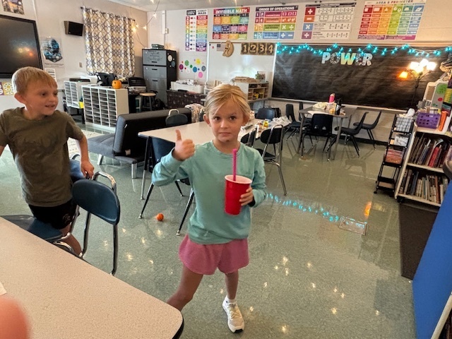 student drinking a green smoothie