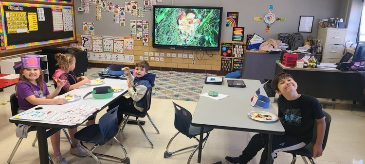 students enjoying an apple snack