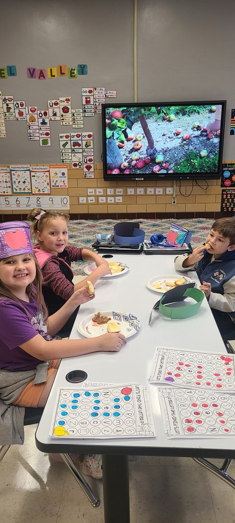 students enjoying an apple snack