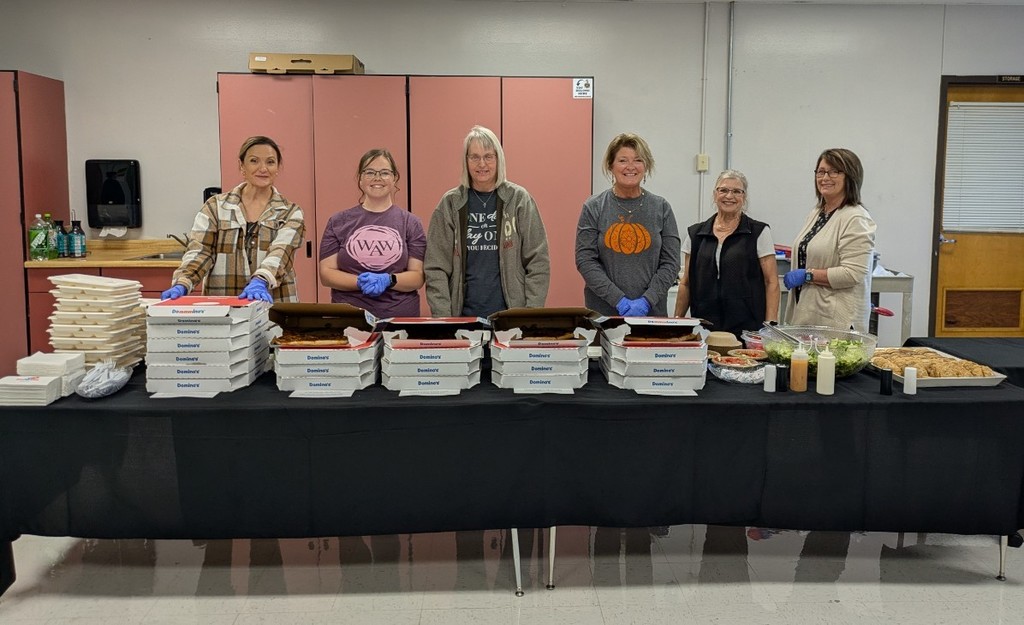 Solid Rock church members serving dinner to staff members during parent-teacher conferences.
