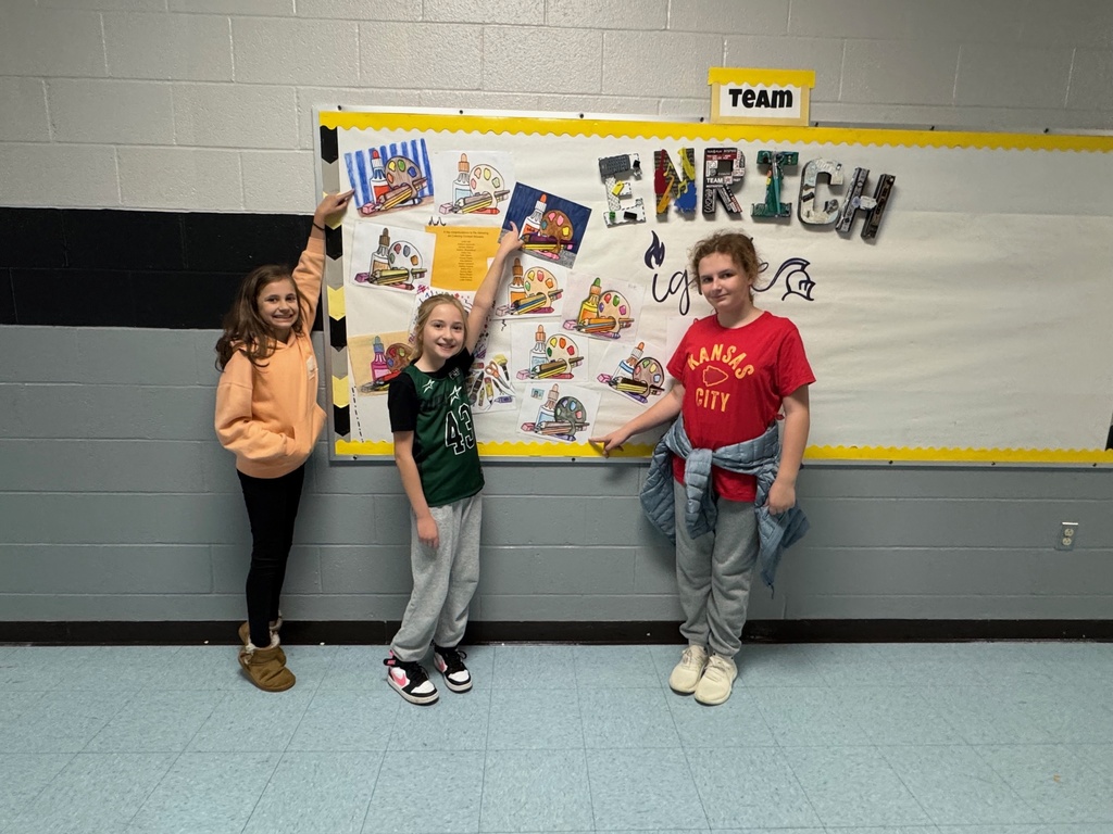 Students showing their coloring contest entries.  