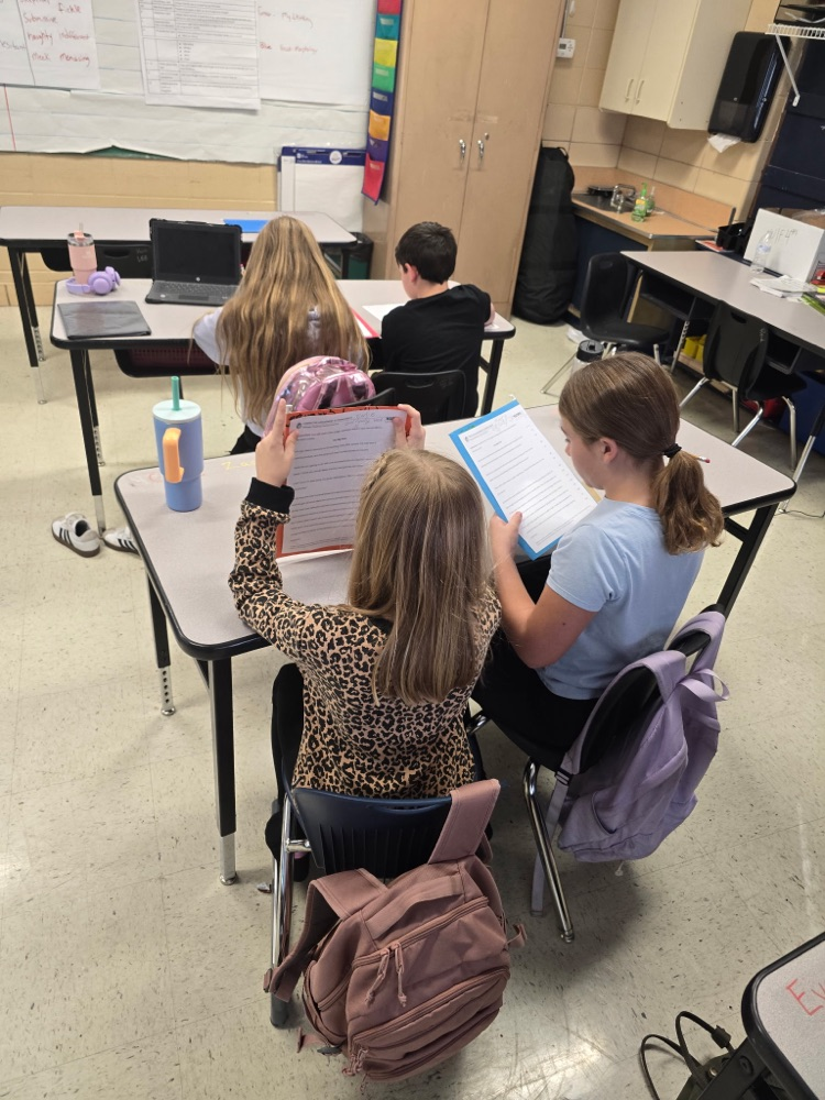 Mr. Lee's class practicing fluency with their partners.