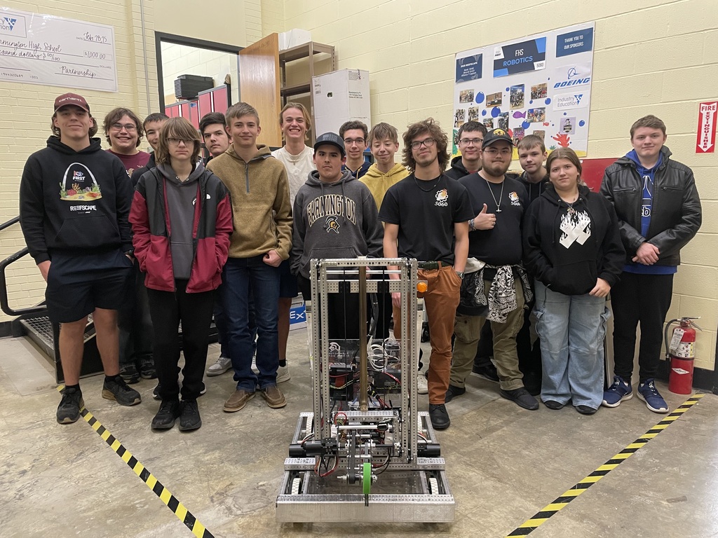 photo of the robotics team with their robot