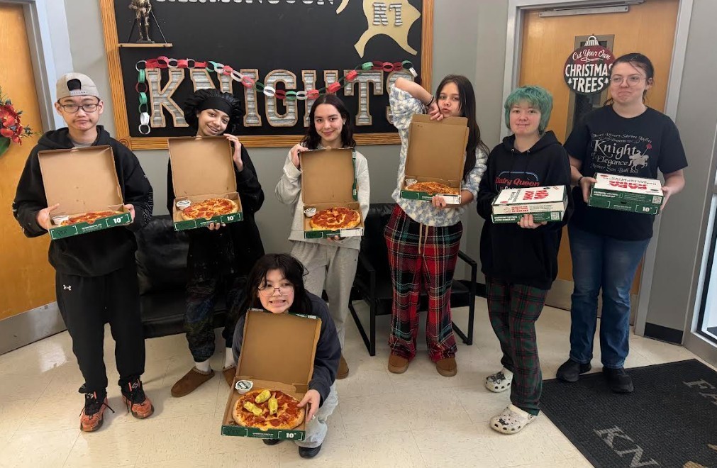 students with their pizza from papa johns
