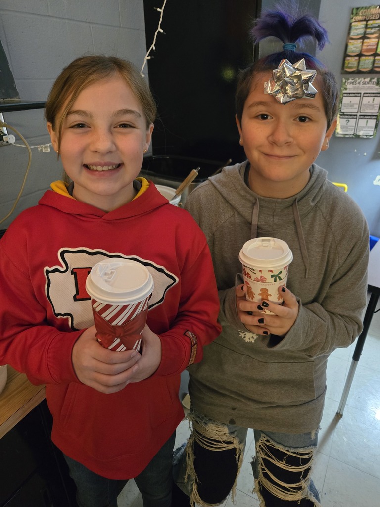 Students enjoying a holiday breakfast.  The classroom is decorated for the holidays.  