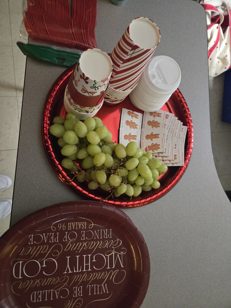 Students enjoying a holiday breakfast.  The classroom is decorated for the holidays.  