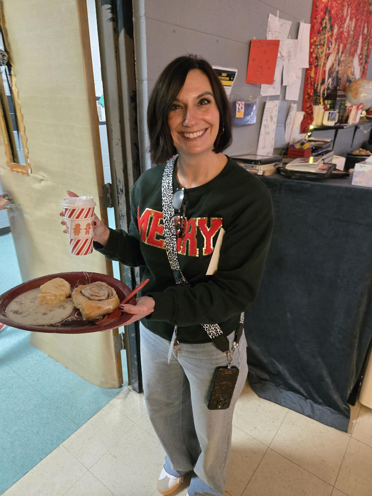 Students enjoying a holiday breakfast.  The classroom is decorated for the holidays.  