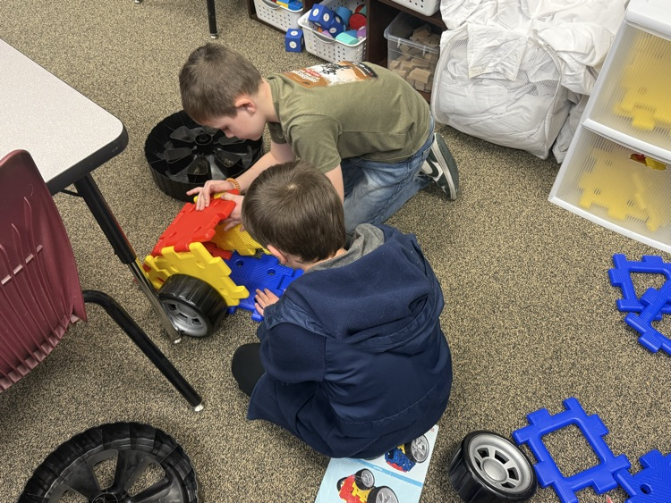 students building with STEM materials