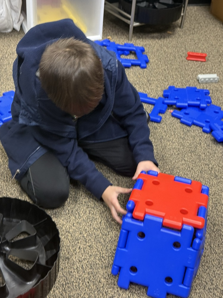 students building with STEM materials