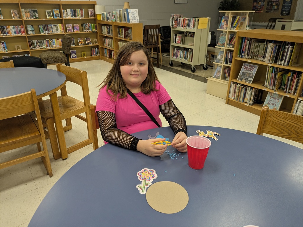 Students making crafts in the library.