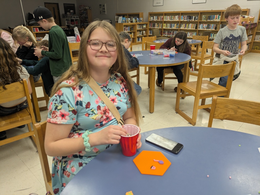 Students making crafts in the library.