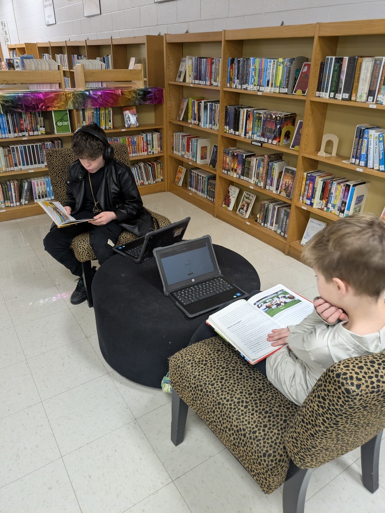 Students reading books in the library.  