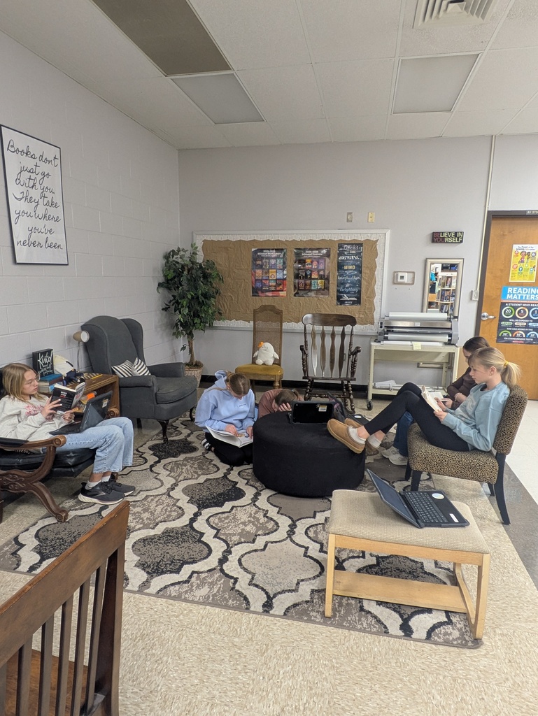 Students reading books in the library.  