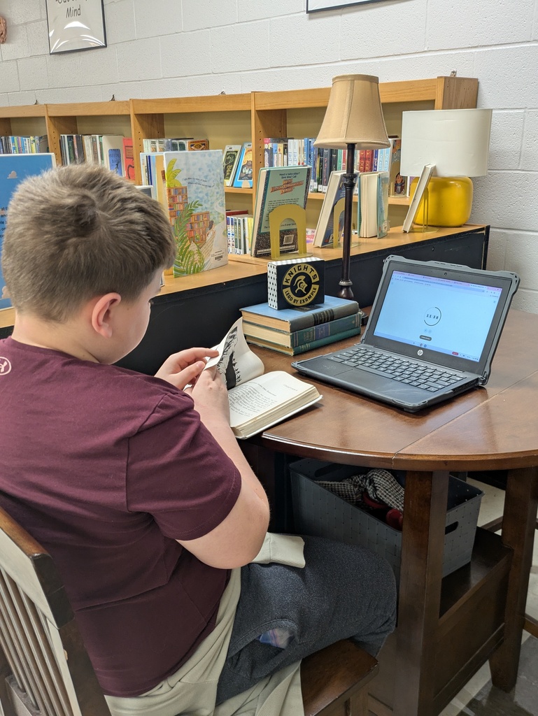 Students reading books in the library.  