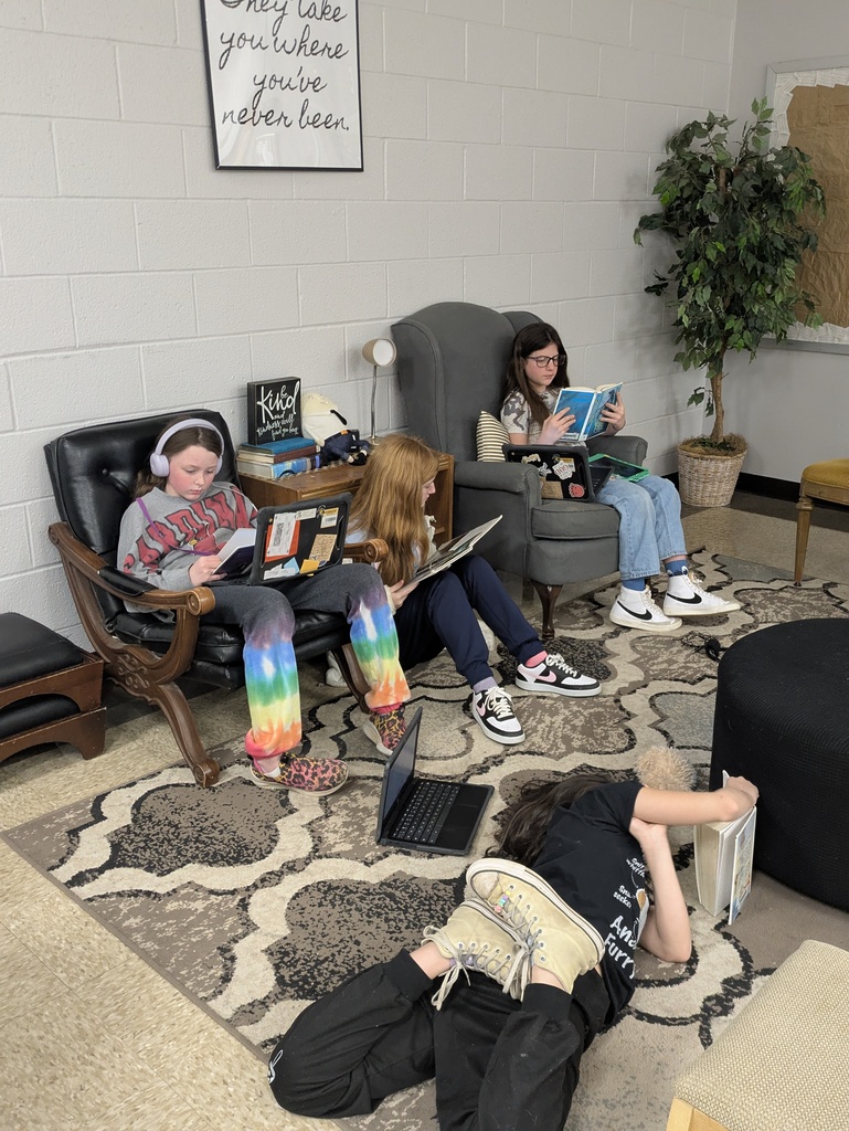 Students reading books in the library.  