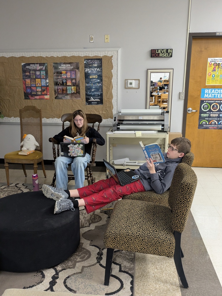Students reading books in the library.  