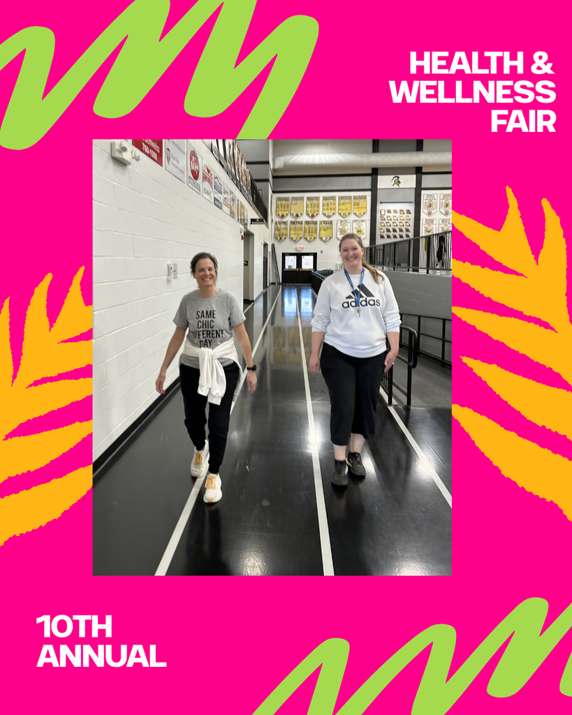 two staff members walking the indoor track