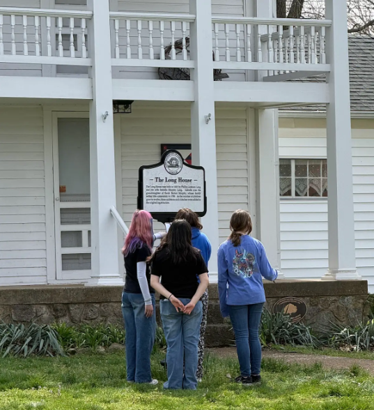 Students look at The Long House