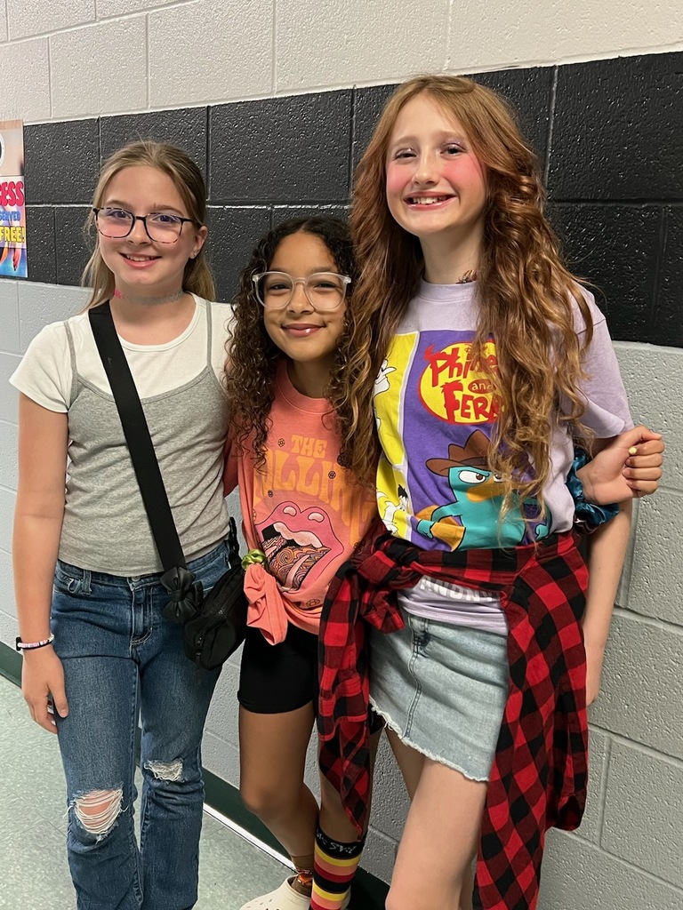 Student smiling in 90's clothes.