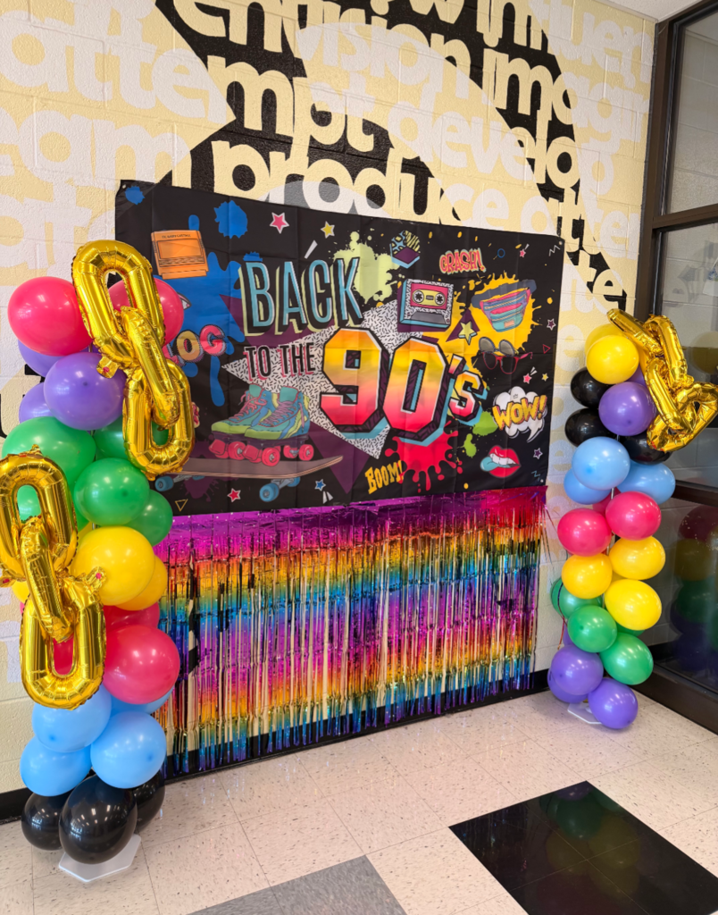Photo backdrop with colorful 90s decor.