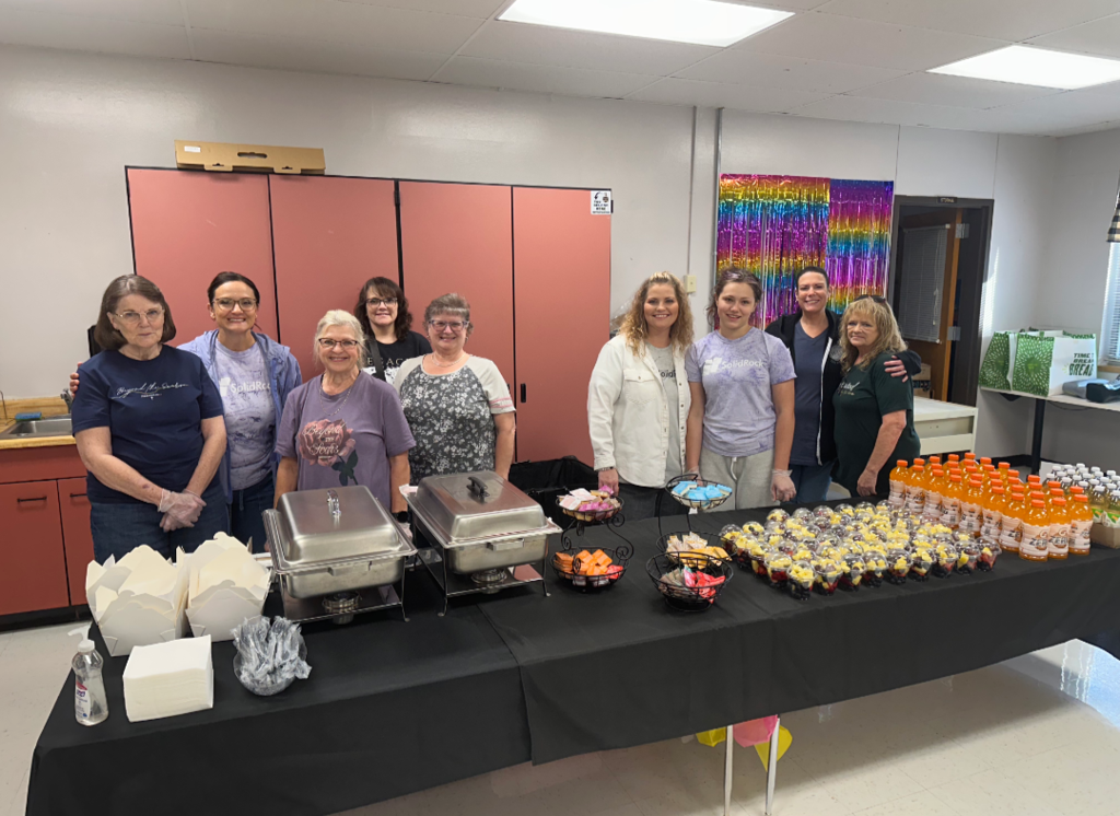 Members of Solid Rock Church serving breakfast to staff members.