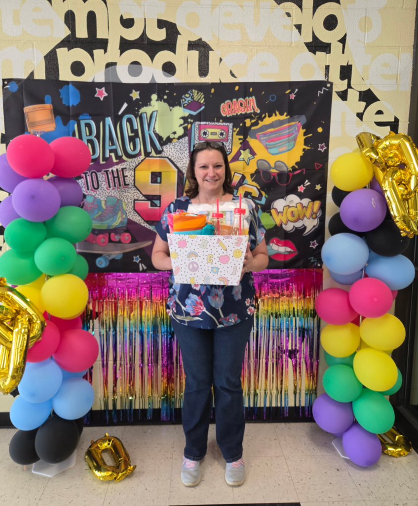 Teacher with gift basket they won for Teacher Appreciation Week
