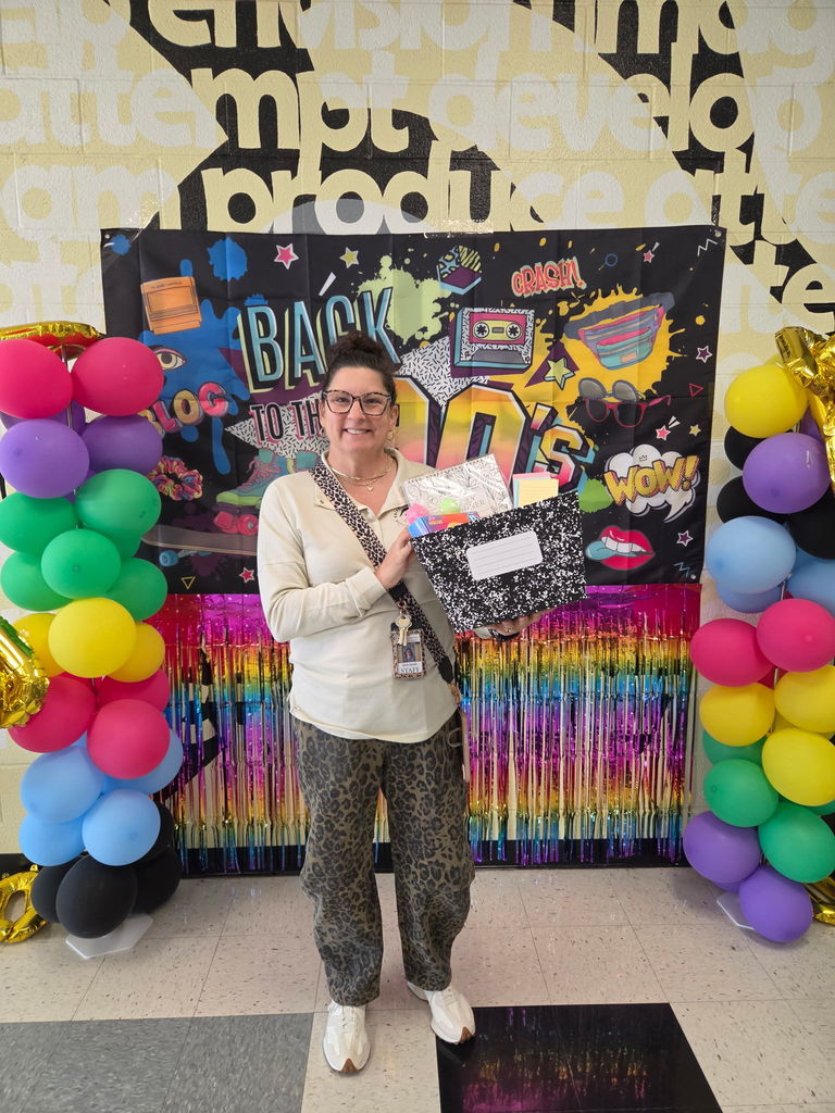 Teacher with gift basket they won for Teacher Appreciation Week