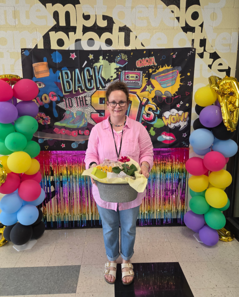 Teacher with gift basket they won for Teacher Appreciation Week