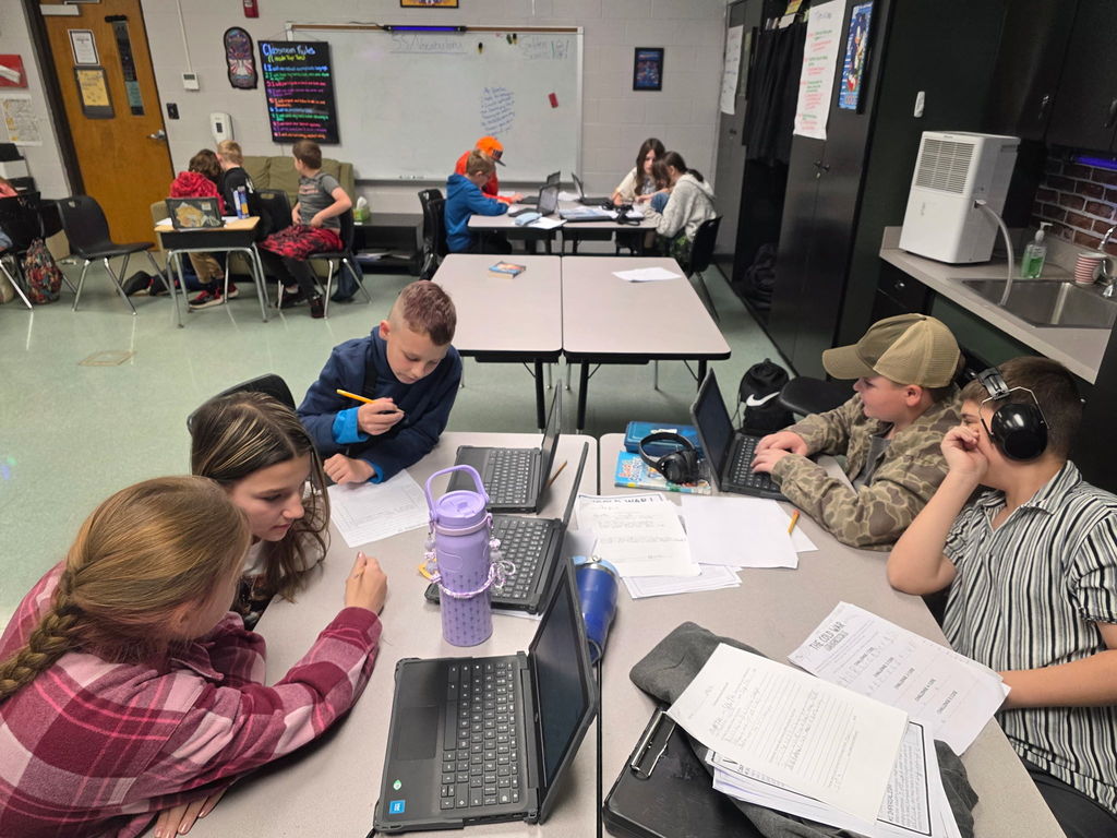 Students working in groups to complete an escape room activity. 